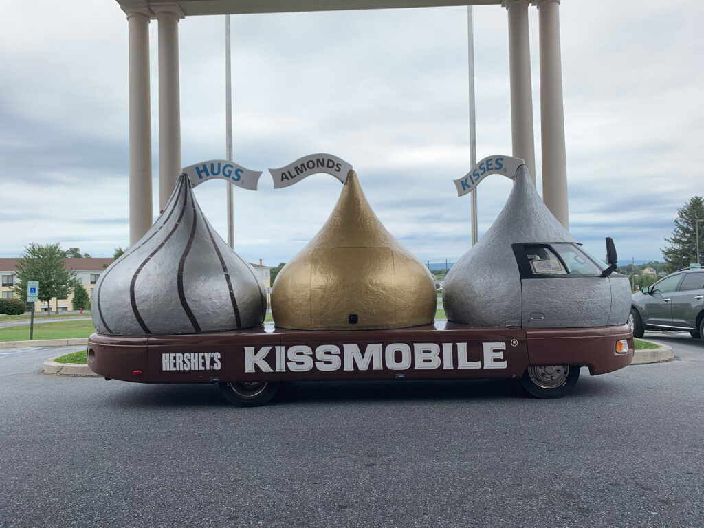 The Herhsey Kissmobile featuring three overside Hershey kisses on a flat bed on display in front of the AACA Museum