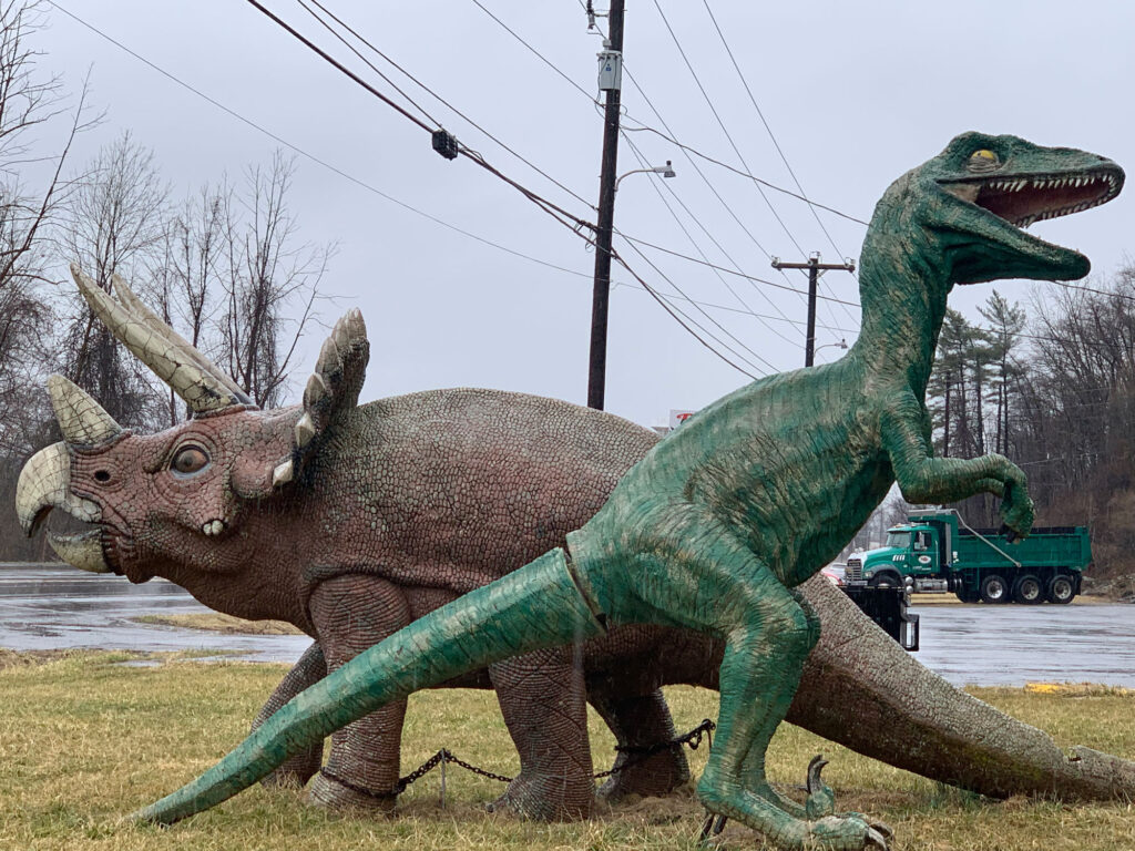 T-Rex and triceratops sculptures outside Bill's Old Bike Barn