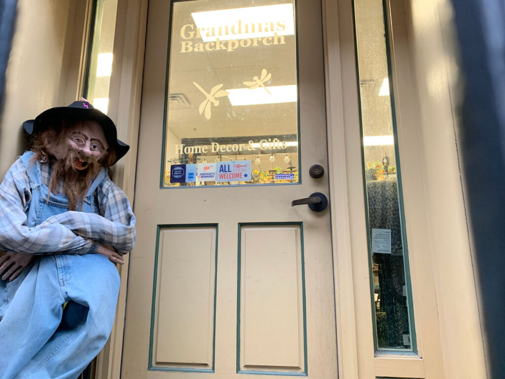 grotesque mannequin dressed in overalls sits outside a storefront in Easton PA