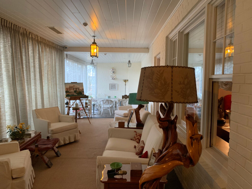 Sun porch at Dwight Eisenhower's former home, featuring an original painting by Eisenhower sitting on an easel. 