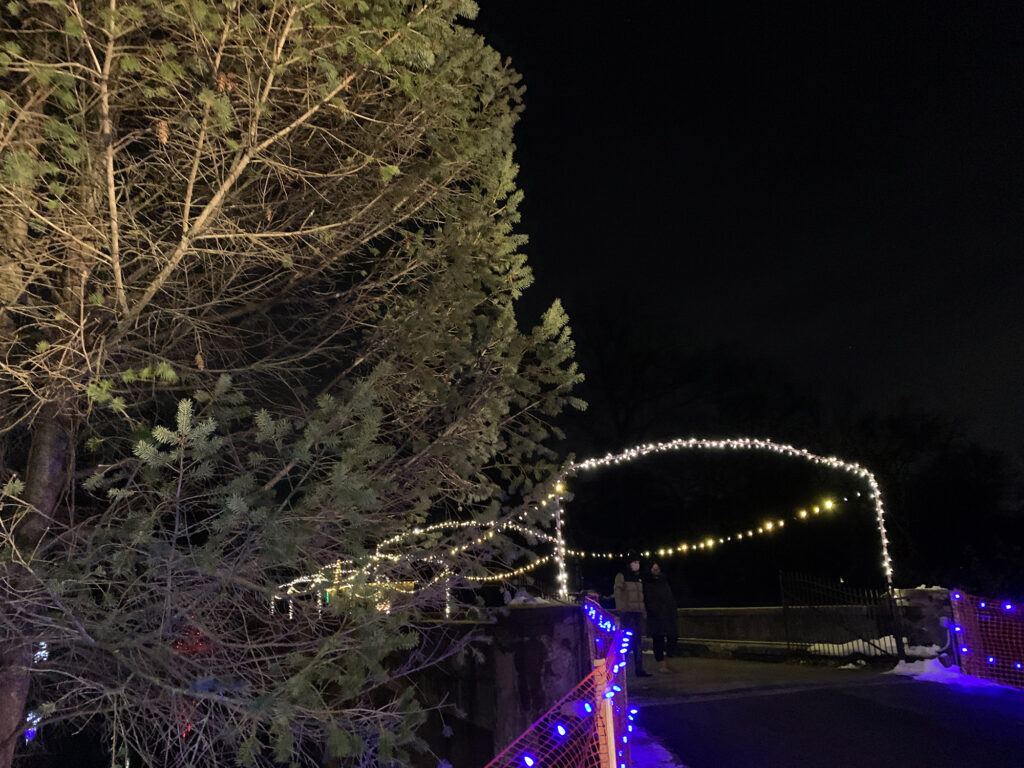 Christmas lights trung across a stone bridge at Gring's Mill