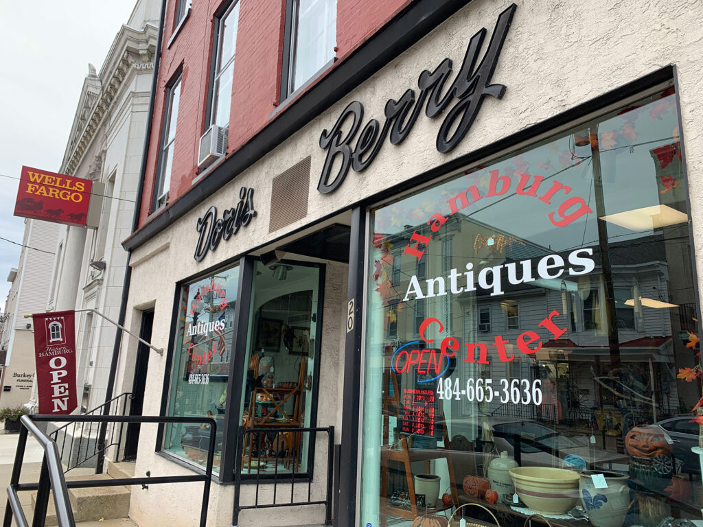 storefront with cursive script reading "Doris Berry" above the windows