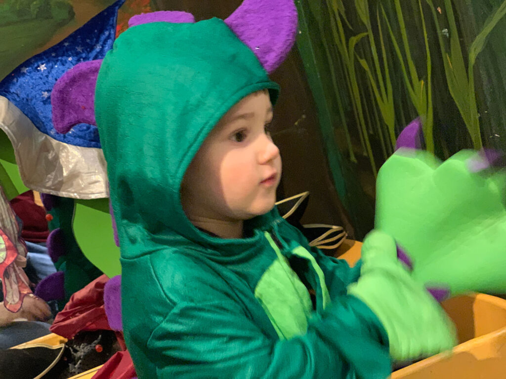 child dressed in a dragon costume at the Hands-On House