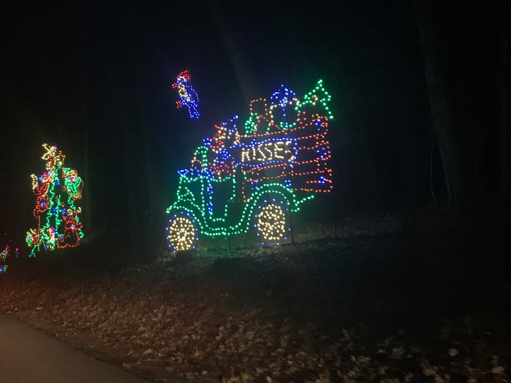 Christmas lights in the shape of a truck filled with Hershey Kisses