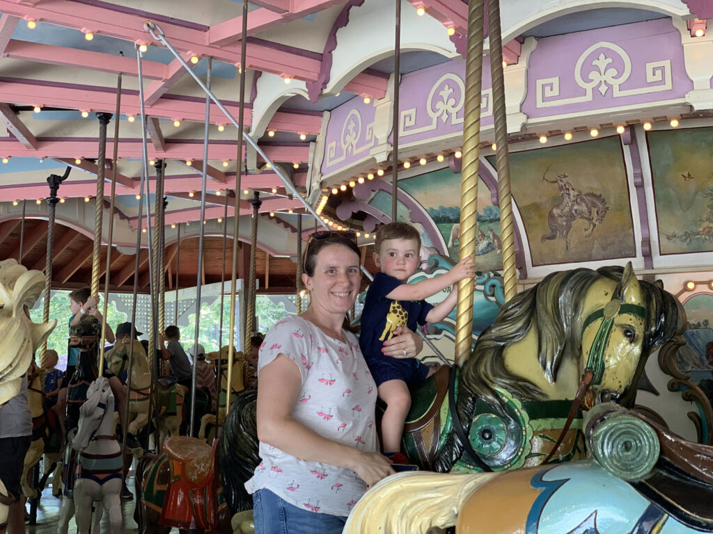 mother and young son on a carousel 