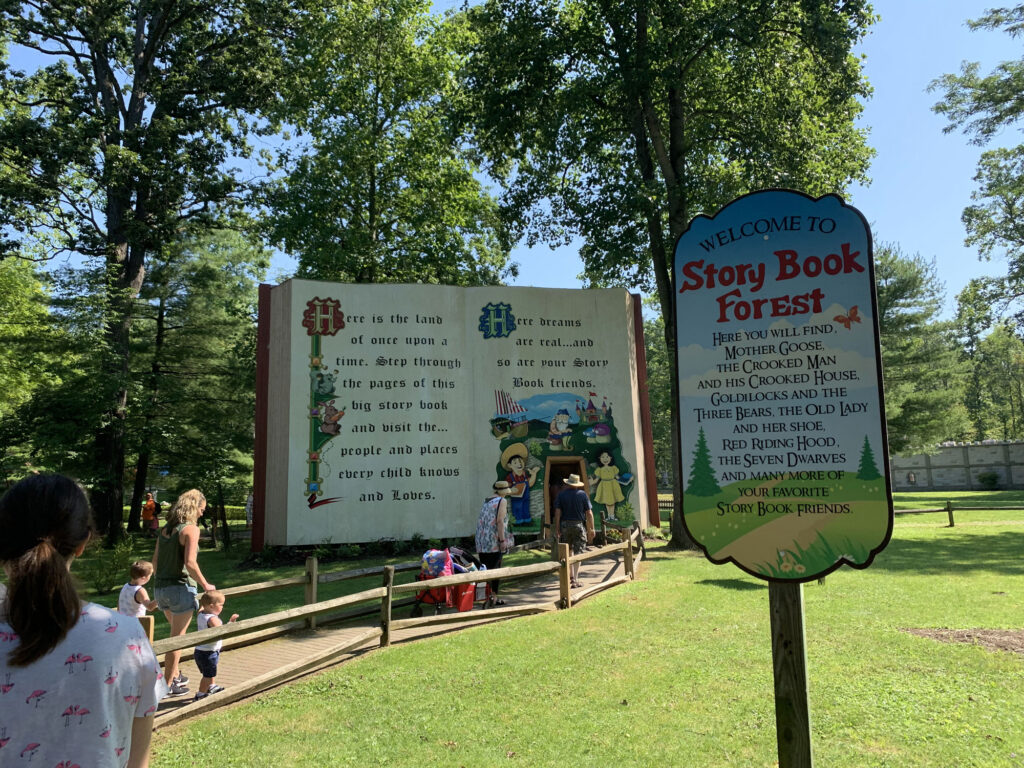 sign shaped like a book at the entrance to Story Book Forest at Idlewild