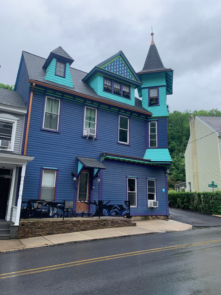 bright blue three-story home with light blue turret in Jim Thorpe, PA