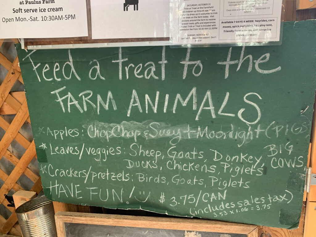 sign advertising feeding a treat to animals at Paulus Farm Market