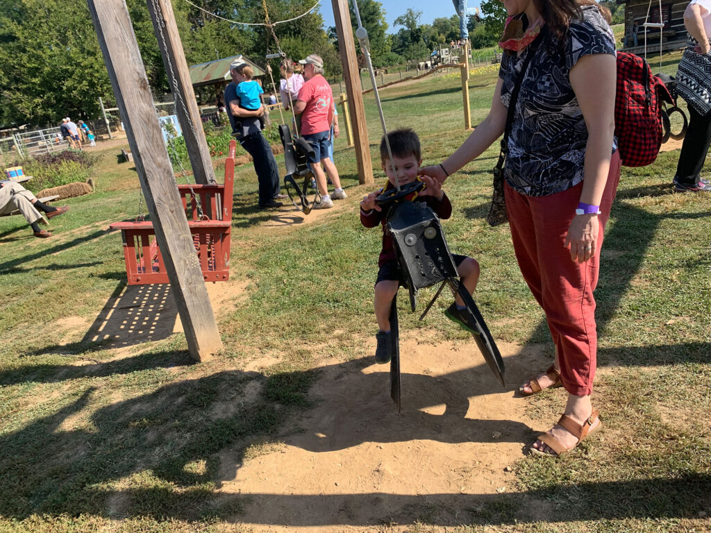 child riding a tire swing at Paulus Farm Market