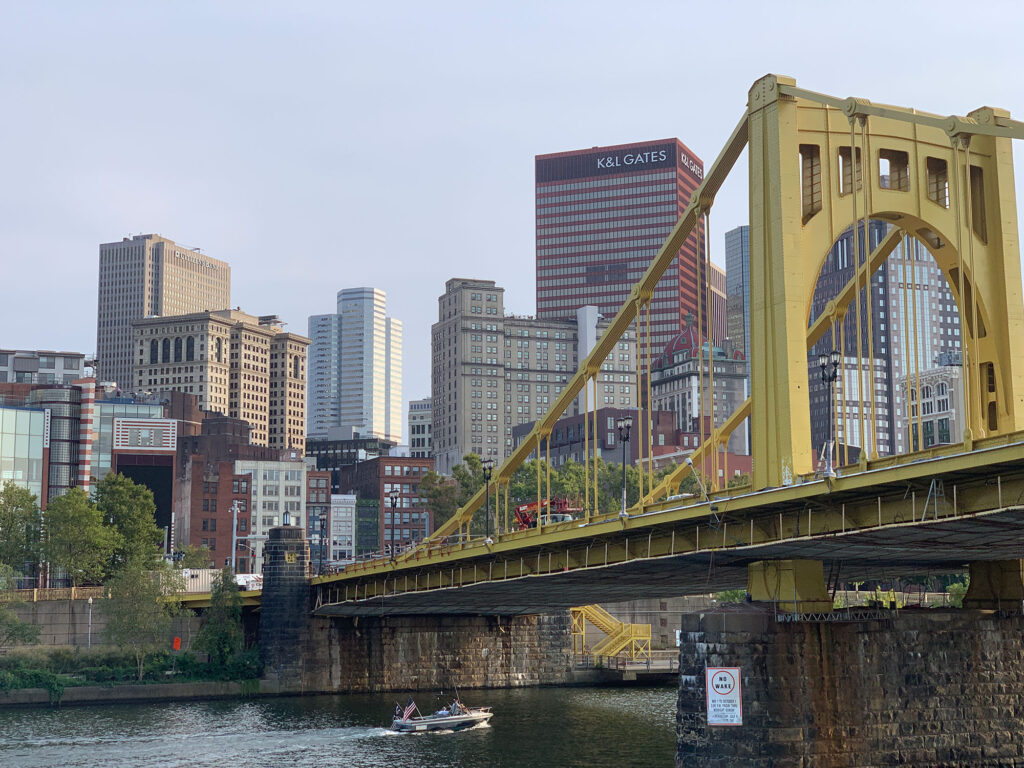 Yellow steel bridge over a river in Pittsburgh, PA