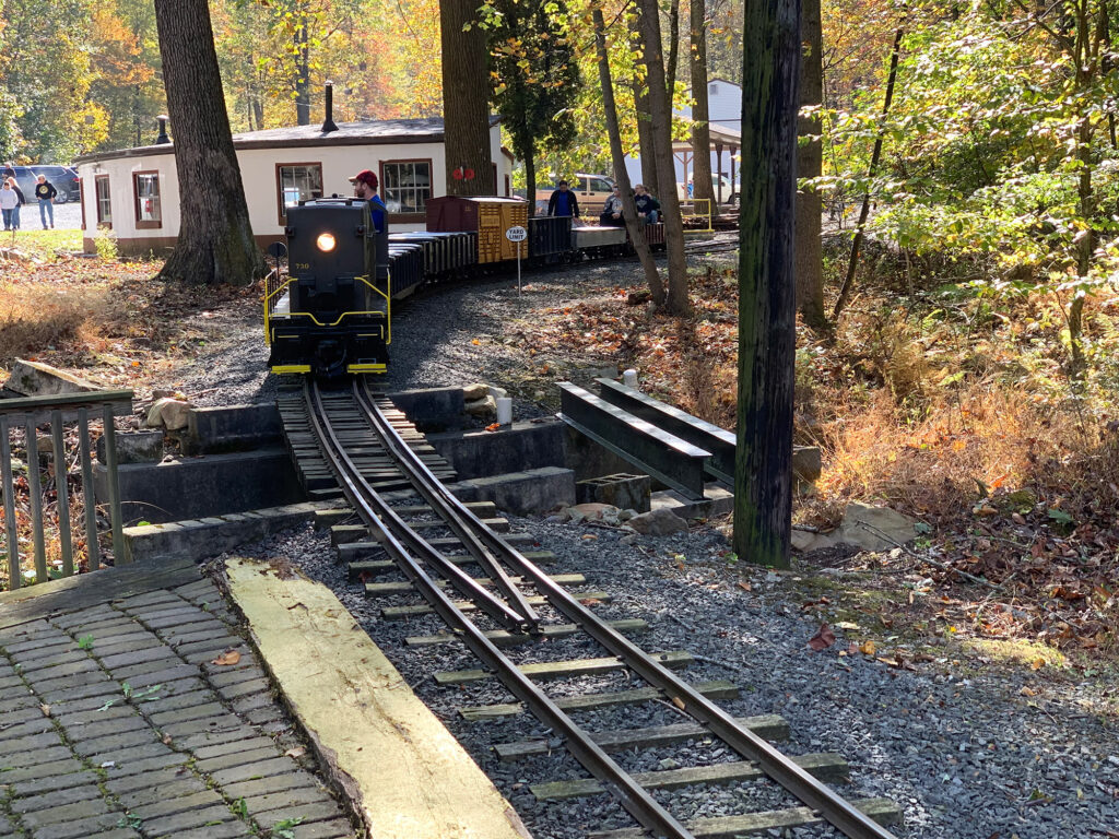 Quarter-size diesel engine pulling passengers on the Laurel Run Railroad