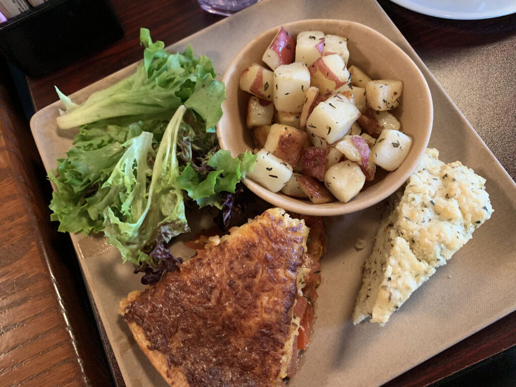 plate with a slice of pie, small sald and diced potatoes from the Tomato Pie Cafe in Lititz, PA