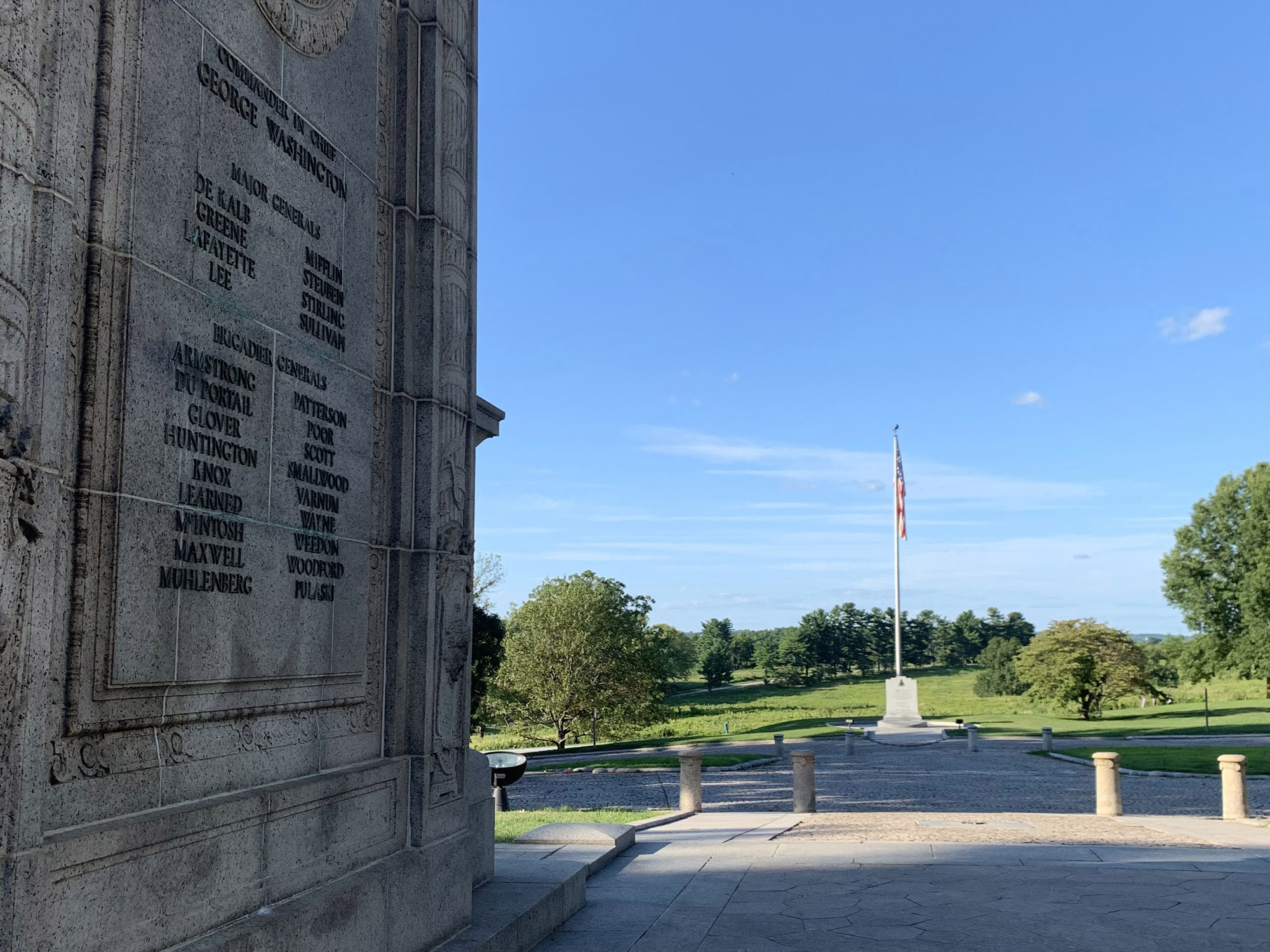 a view from under the National Memorial Arch looking out to a Flagpole at Valley Forge Park