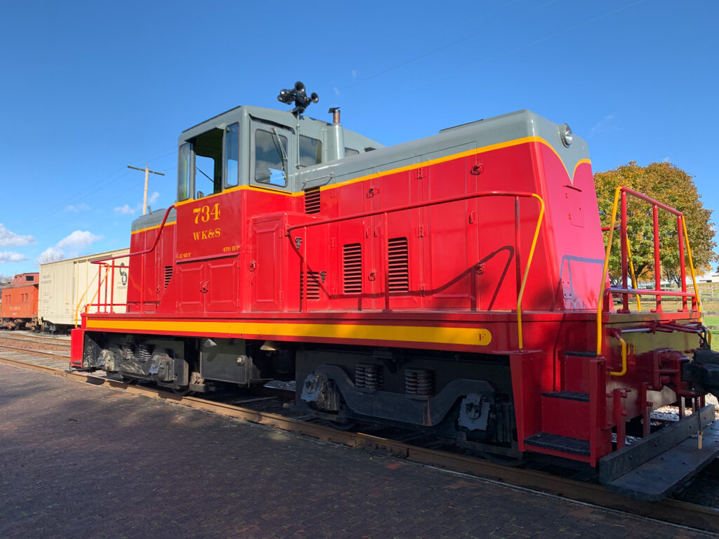 Camelback diesel engine painted red with a green cab at the Wanamaker Kempton and Southern Railroad