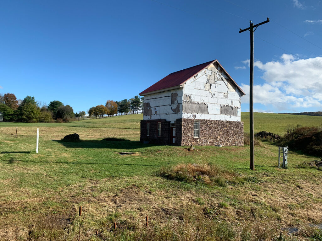 Historic barn stands alone in a field along the tracks of the Wanamaker Kempton and Southern