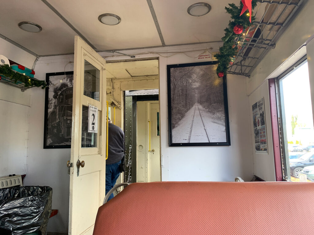 inside a passenger coach with light red leather seats