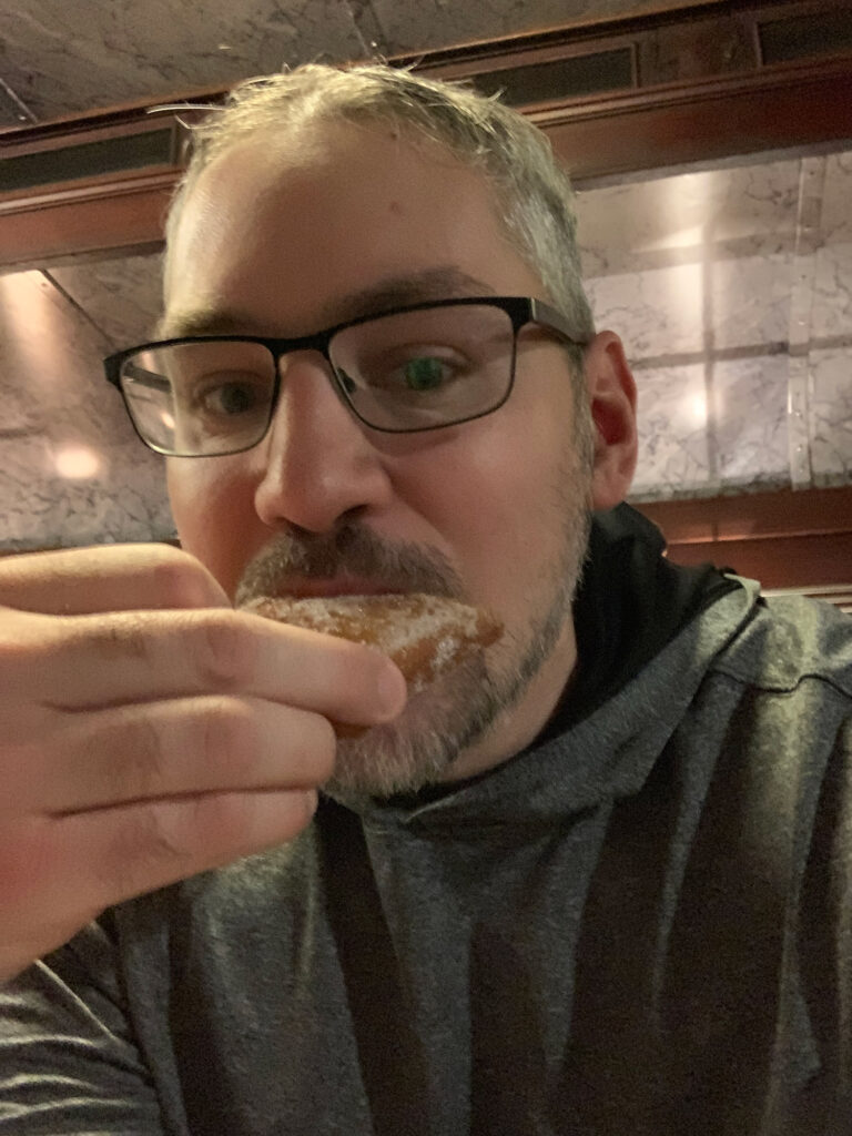 Selfie of a man eating a fastnacht