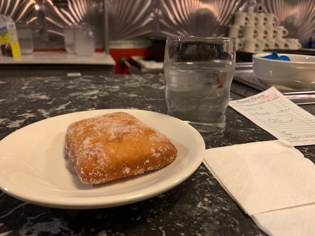 White plate with a potato donut on a marble counter of the Reading Diner inside the Boyertown Museum of Historic Vehicles