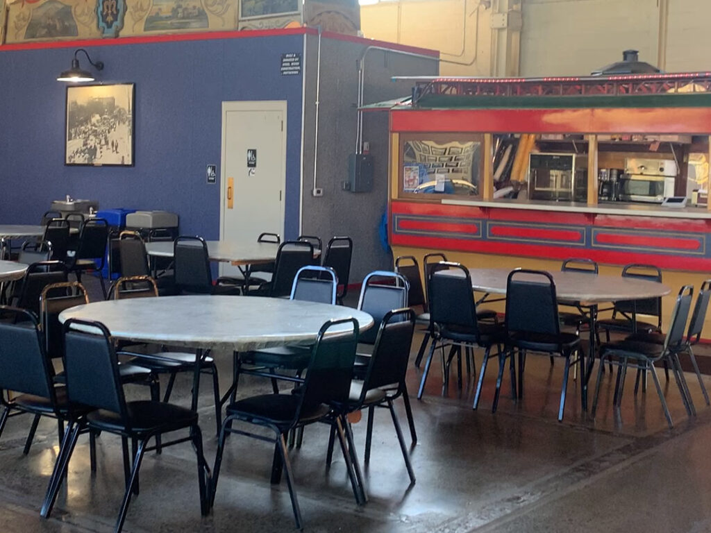 Snack bar made to look like an old-time diner behind a group of round tables with black chairs at the Carousel at Pottstown