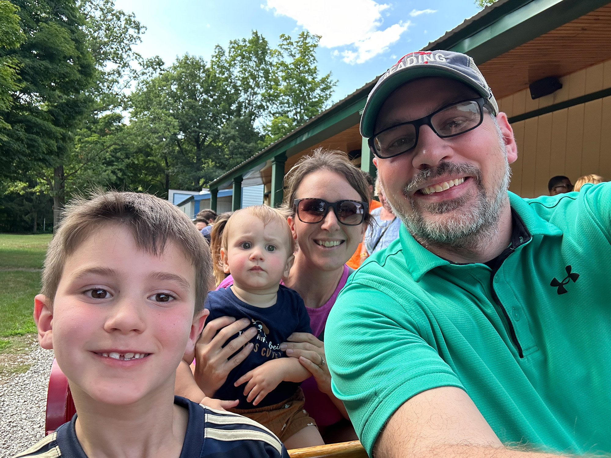 family of four riding a miniature railroad