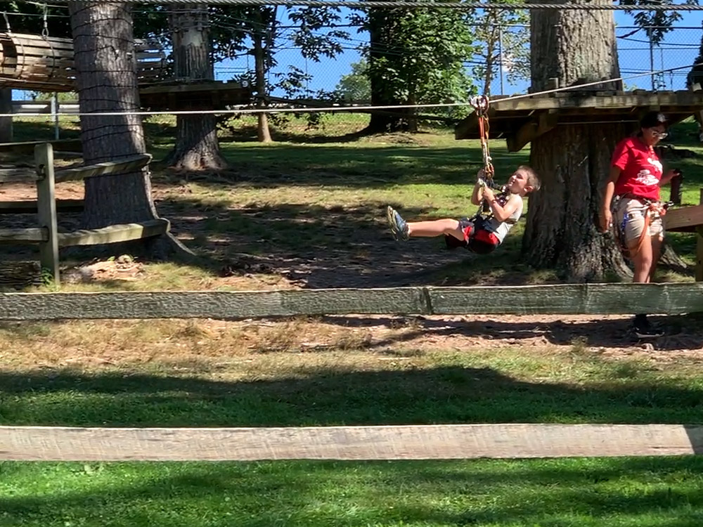 small child doing a zipline at the Elmwood Park Zoo