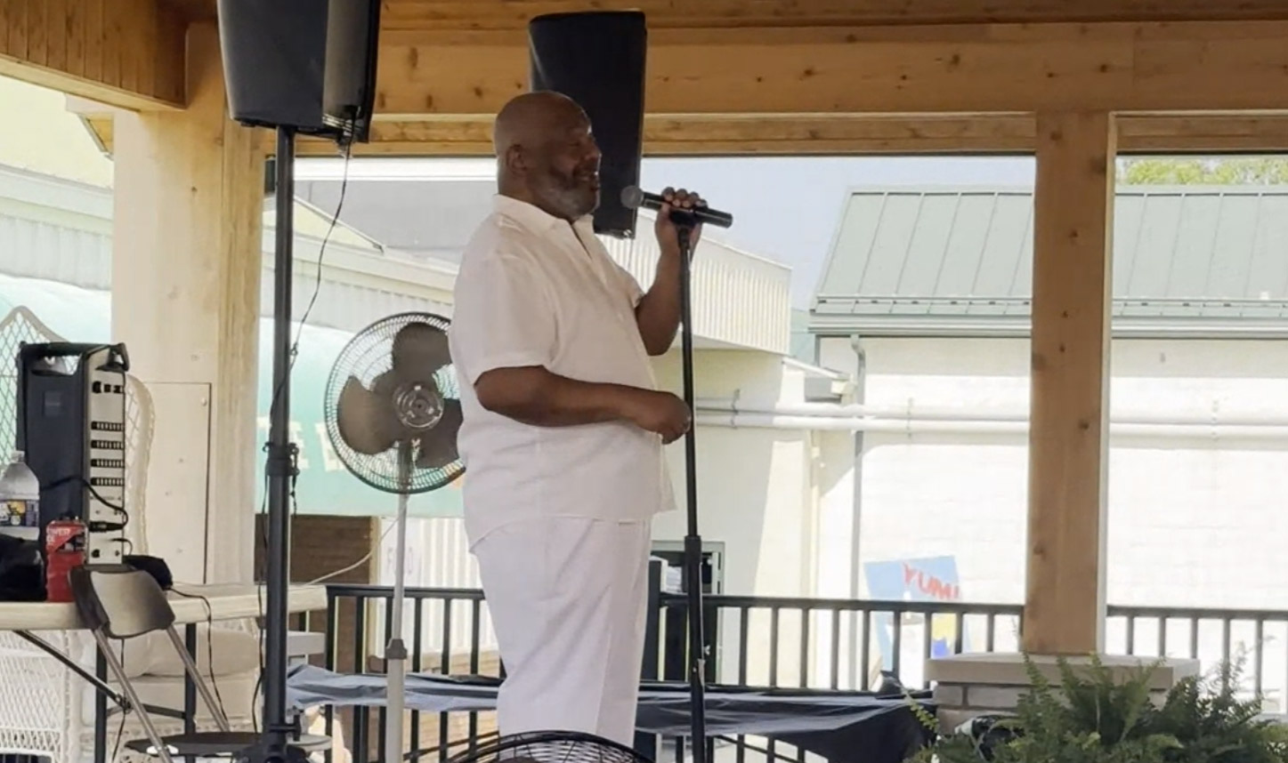 man singing on a small stage at the Lebanon Fair