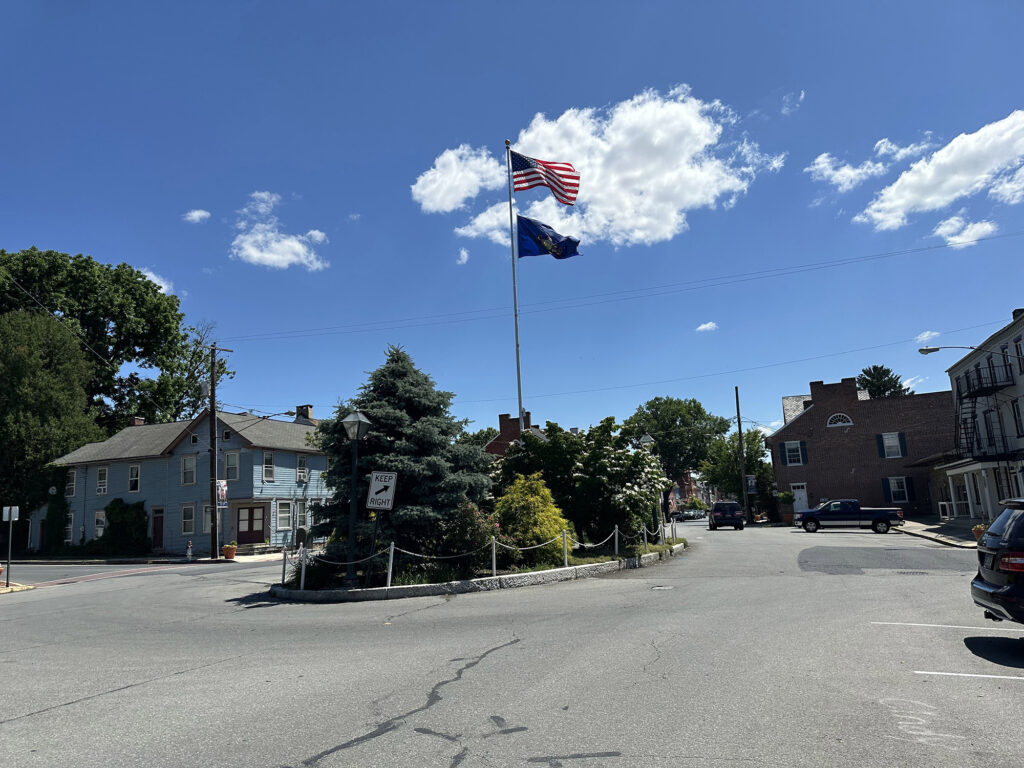 historic square in Marietta PA with a flag pole flying the United States and Pennsylvania flags