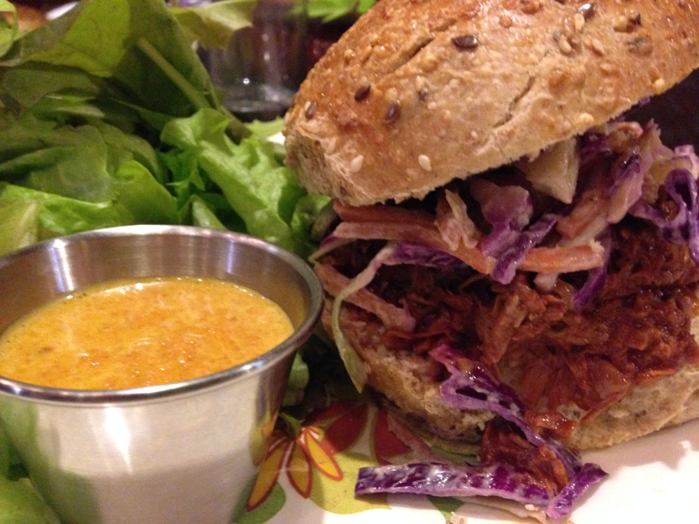 Pulled jackfruit sandwich with a side salad