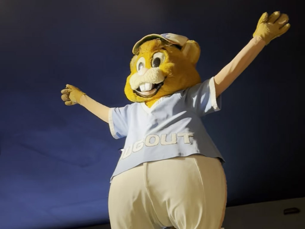 Little League mascot "Dugout" with arms outstretched