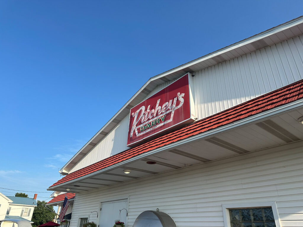 White barn-like buiding with red sign reading "Ritchey's Dairy"