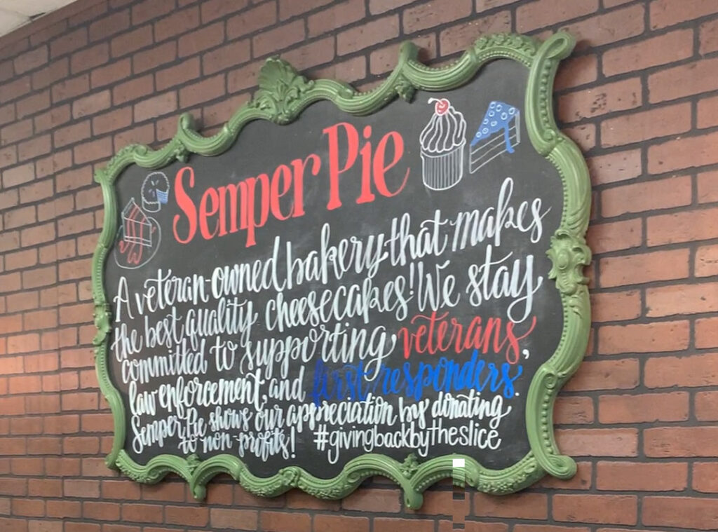 sign reading "Semper Pie" with drawings of cupcakes and cheesecakes