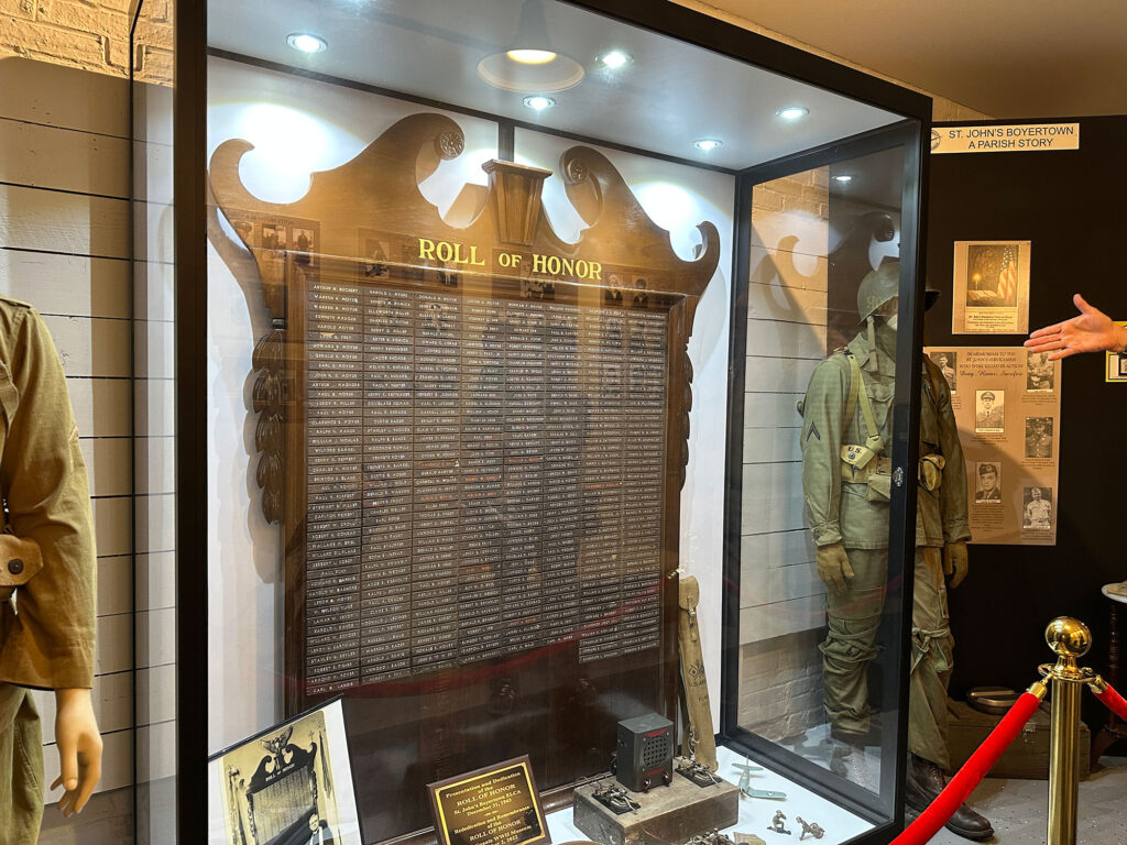 large wooden plaque with more than 300 names engraved on small plates and the title "Roll of Honor" at the top