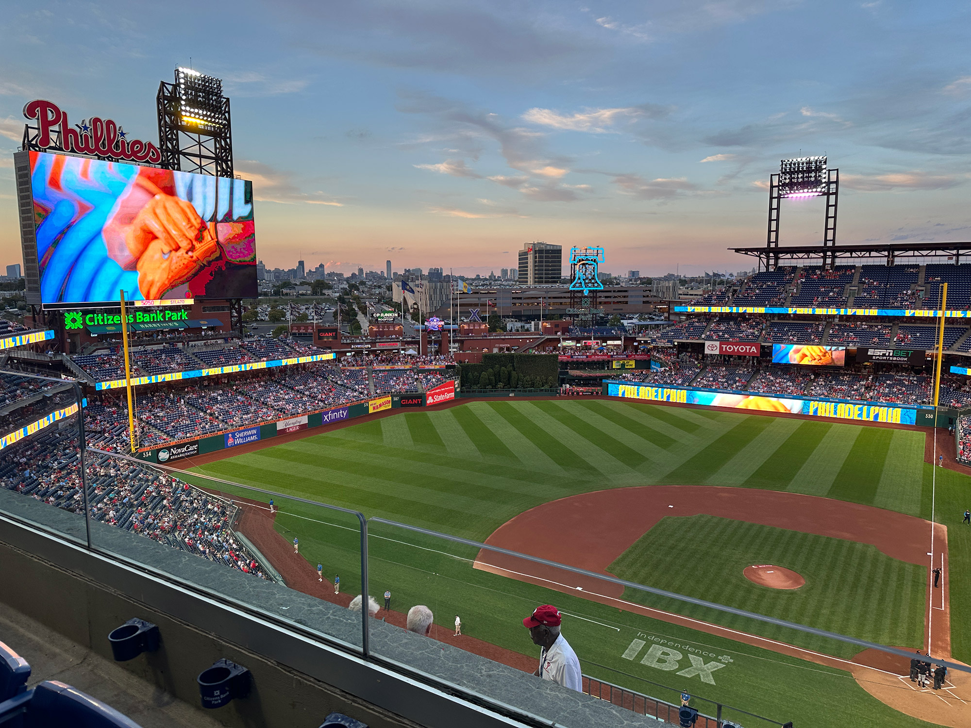looking out from an upper deck seating area at the playing field at Citizens Bank Park in Philadelphia at twilight