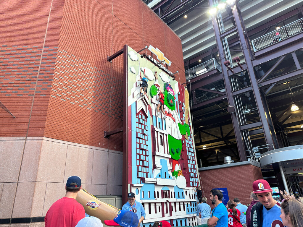 climbing wall at Citizens Bank Park in Philadelphia featuring an image of the Phillie Phanatic climbing Independence Hall