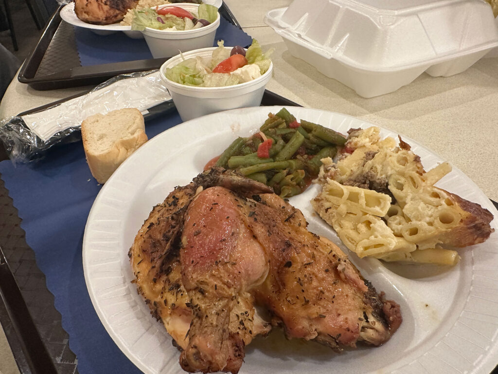 styrofoam plate with half a chicken, a helping of pasta, and a side of green beans from the Greek Food Bazaar in Reading, PA.
