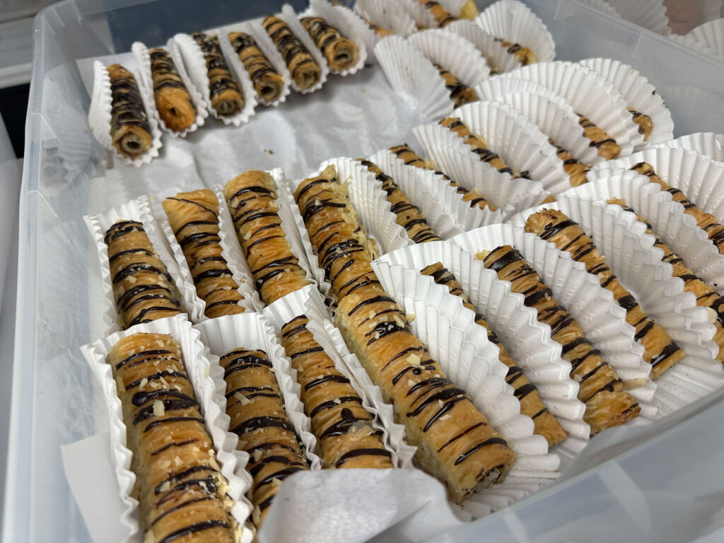 rows of cylindrical pastries drizzled in chocolate from the Greek Food Bazaar in Reading, PA.
