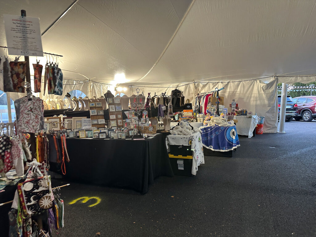 tent filled with vendors selling trinkets and candy.
