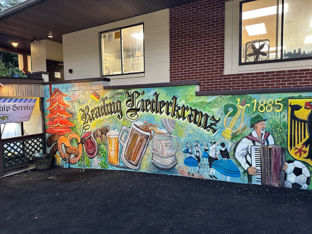 Mural outside the Reading Liederkranz depicting the club name with beer steins, an accordion player, and the Reading Pagoda