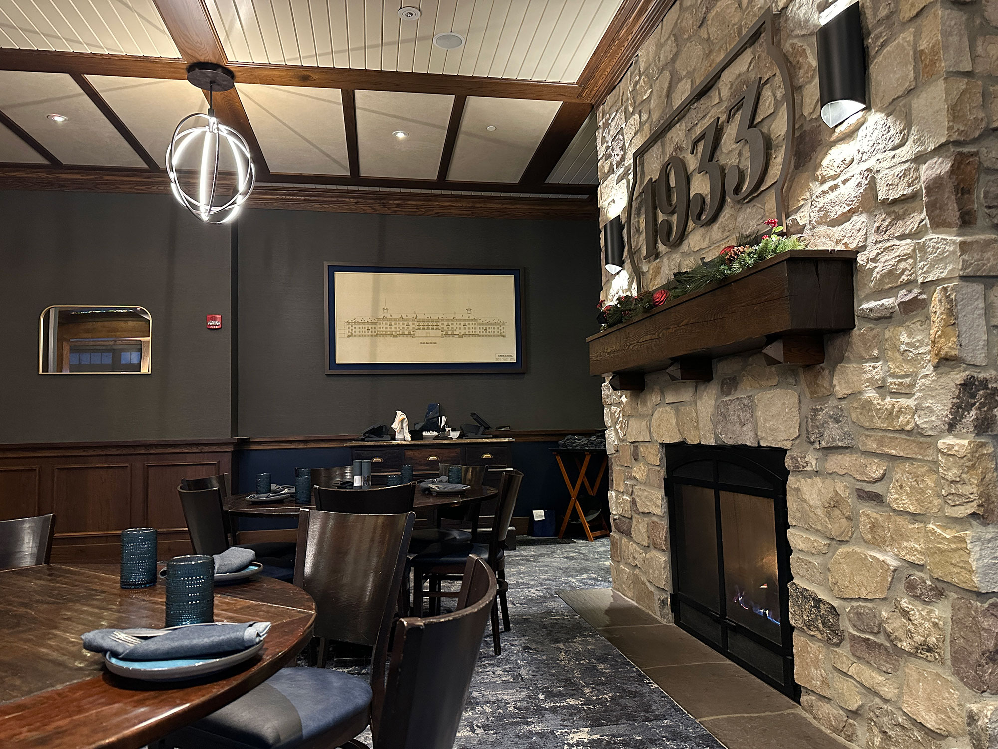 fireplace inside a restaurant dining roo with the number 1933 above the mantle