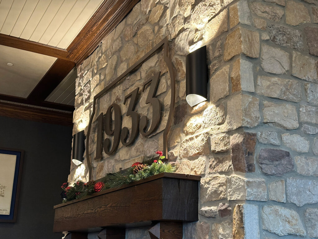 close-up picture of the number 1933 in metal against a stone wall