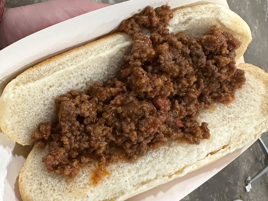 hot dog bun topped with ground goat meat in sloppy Joe sauce from the PA Farm Show