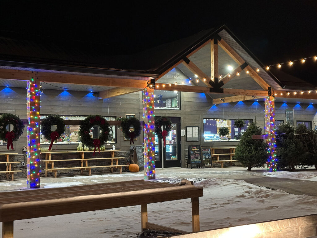 wreaths hang from a post outside Hume's Blooms in Wellsboro, PA