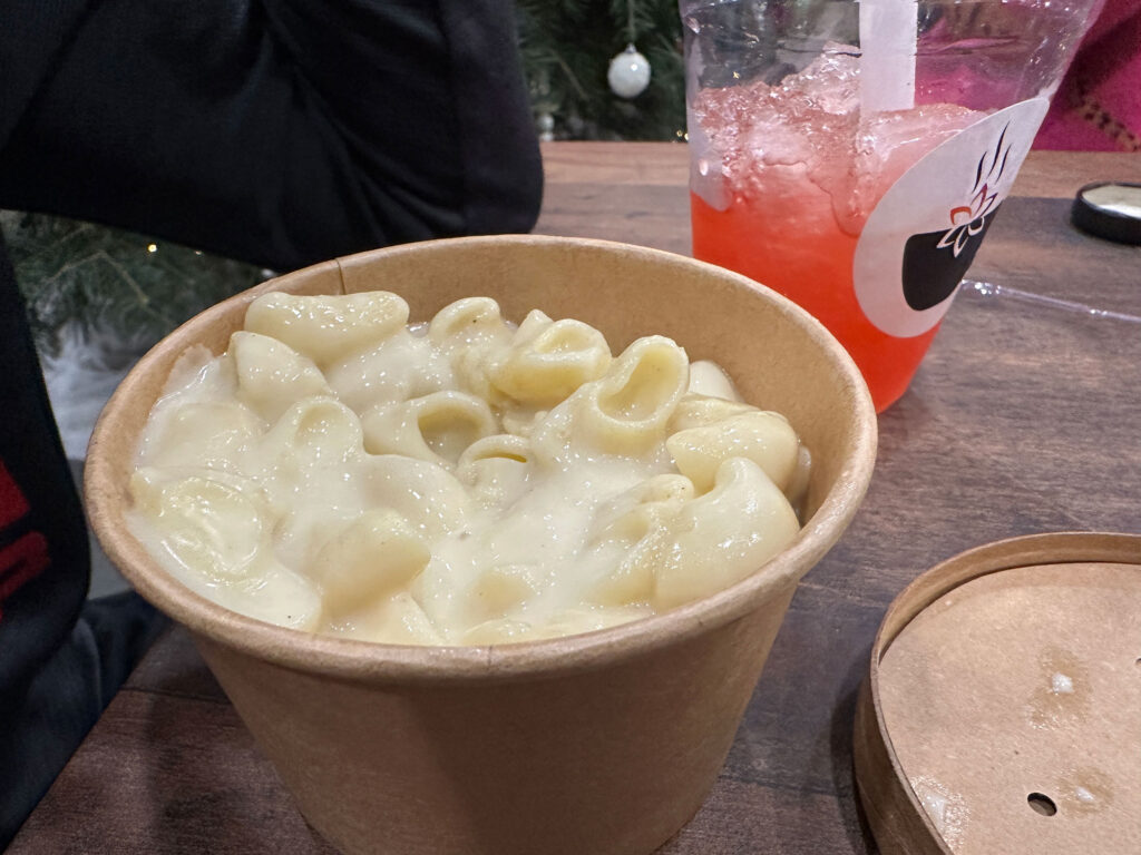 small brown cardboard bowl with shell-shaped mac and cheese