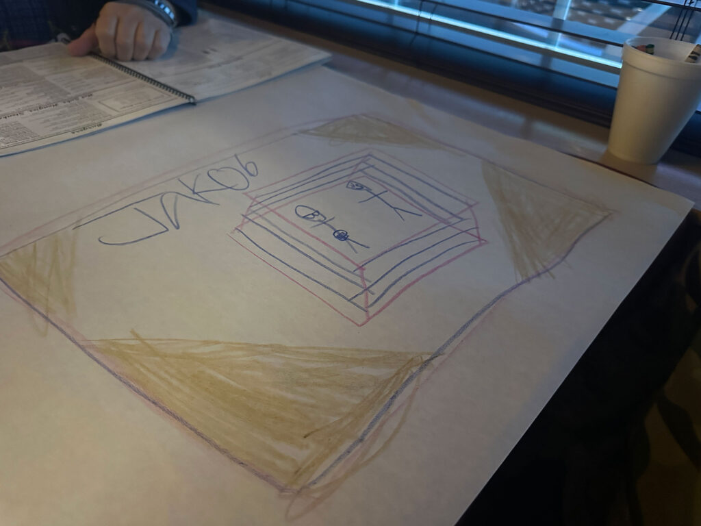 large white paper with a drawing of two people in a wretling ring