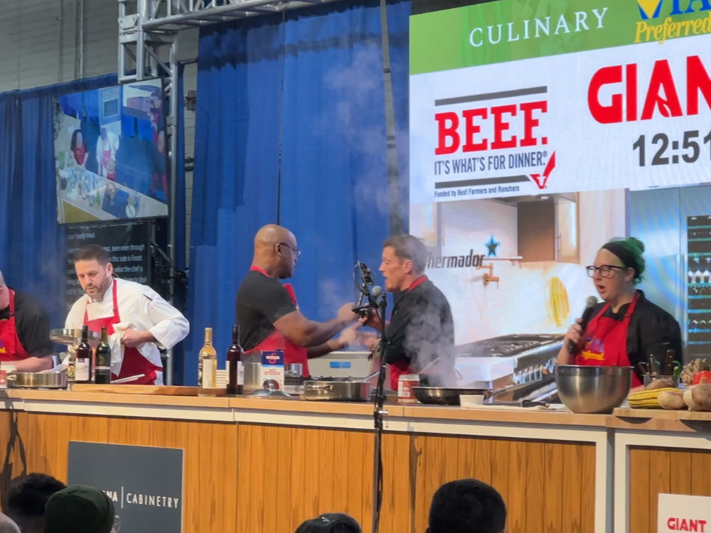 four people on a stage during a cooking competition