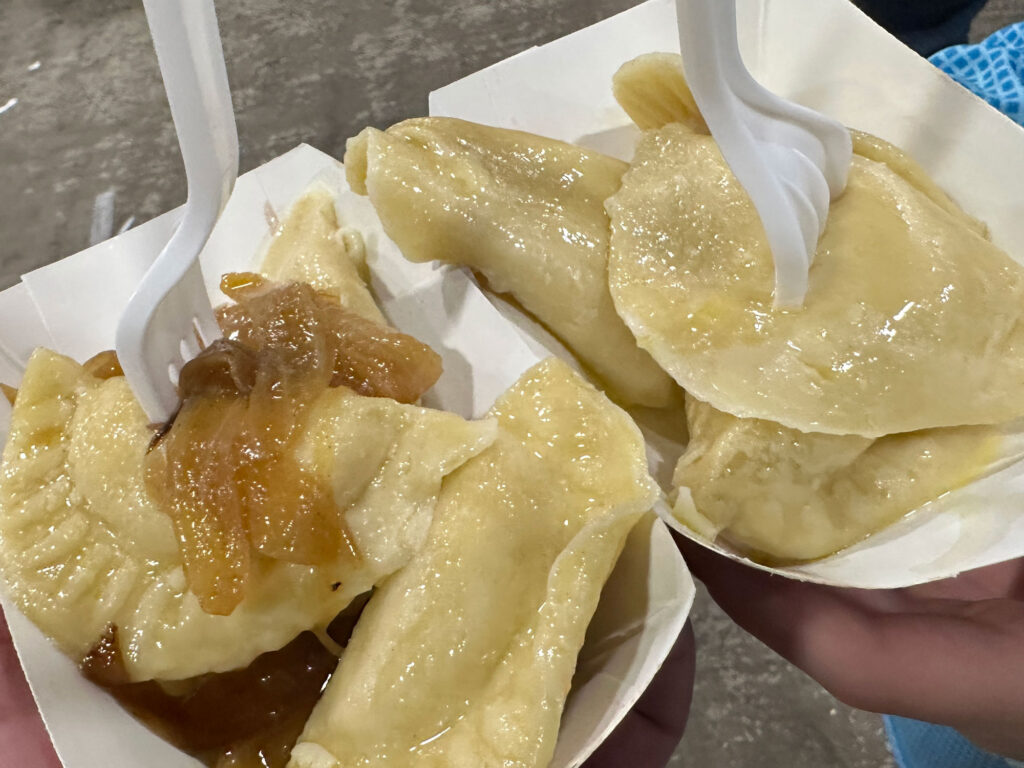 two orders of pierogies in takeout boats - one topped with onions, one not - from the PA Farm Show