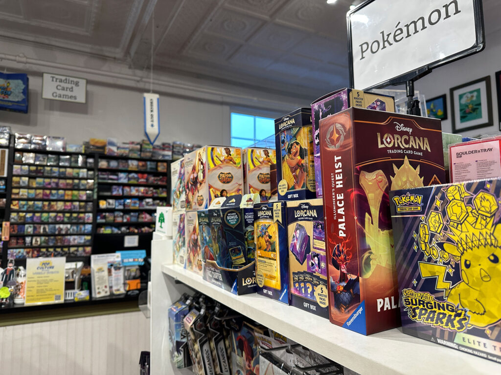 A shelf of Pokemon cards in collectors boxes inside Pop's Culture Shoppe in Wellsboro, PA