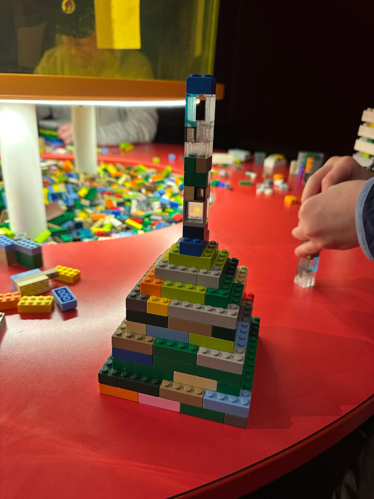 multi-colored LEGO pyramid with a spire on top