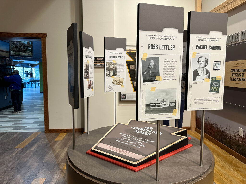 display with a keystone-shaped plaque in the center surrounded by signs naming "conservation heroes" of Pennsyvlania